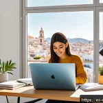 Home 19 디지털 공유경제에서의 수익 창출 방법 - A modern digital freelancer workspace in a bright home office in Spain, featuring a young profession...